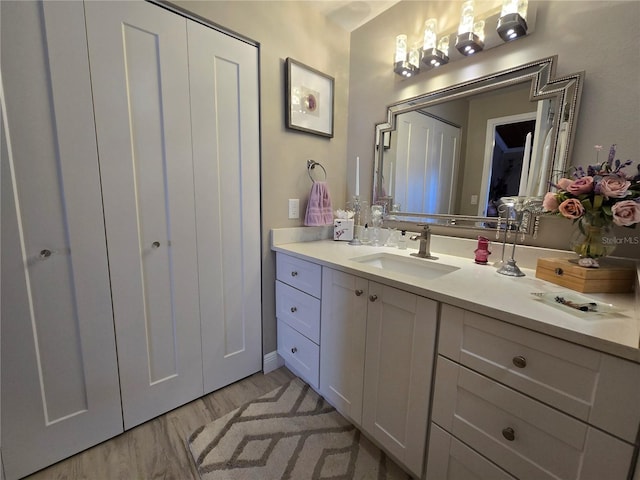 bathroom with vanity and wood finished floors