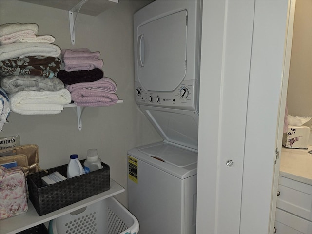 clothes washing area with stacked washer / drying machine