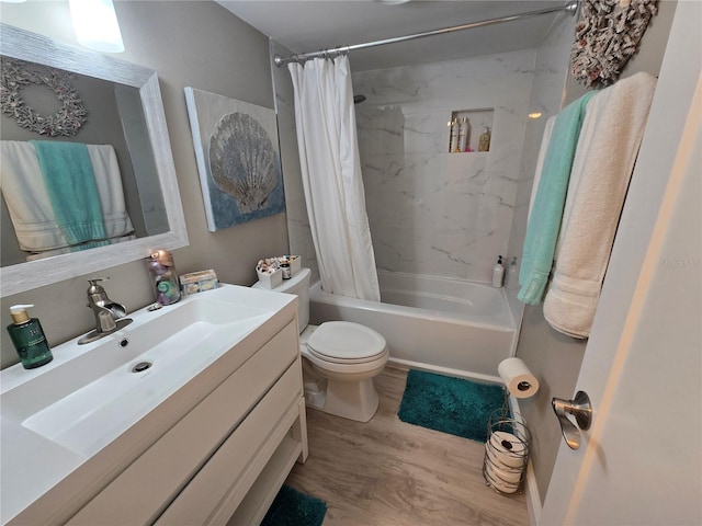 full bathroom featuring wood finished floors, shower / tub combo with curtain, toilet, and vanity