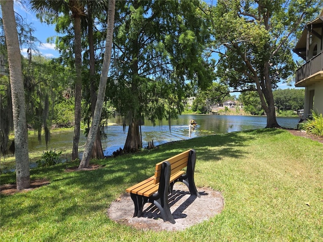 view of green lawn with a water view