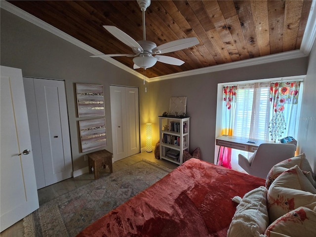 bedroom with wood ceiling, crown molding, multiple closets, wood finished floors, and vaulted ceiling