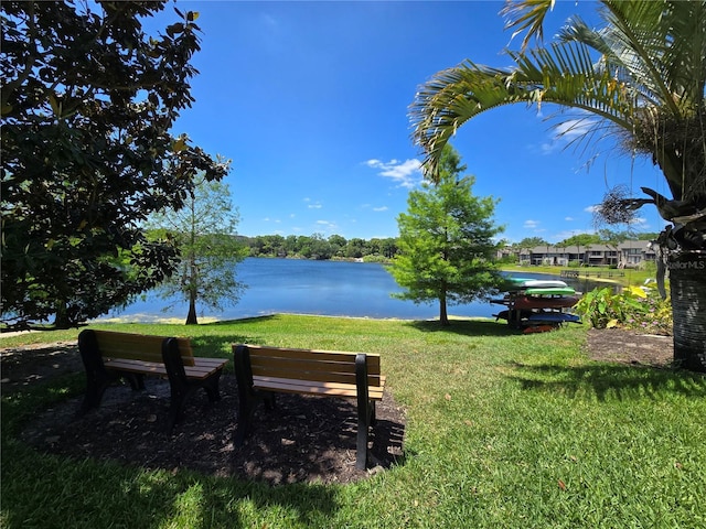 surrounding community featuring a water view and a yard
