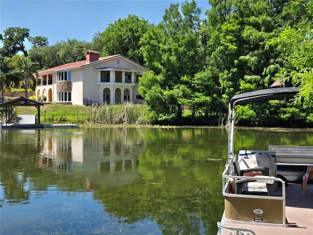 dock featuring a water view and view of scattered trees