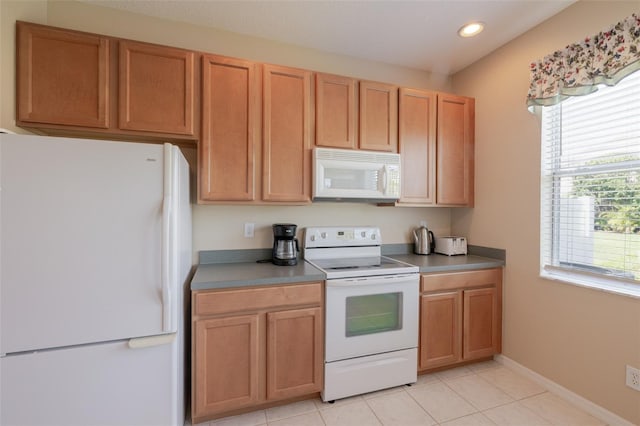 4103 Foristall Ave Unit 4103, Sarasota, FL 34233 - kitchen featuring white appliances, recessed lighting, light tile patterned floors, and baseboards