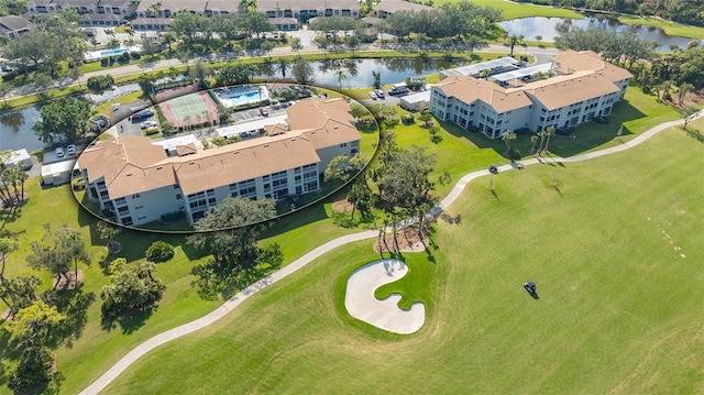 aerial view of a large body of water, a golf course, and apartment complex / building