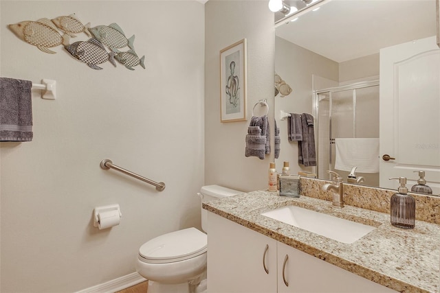 full bath with a stall shower, toilet, and vanity