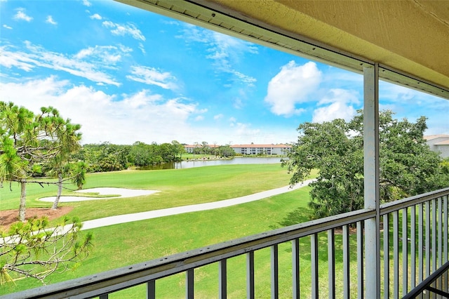 balcony with a water view and golf course view