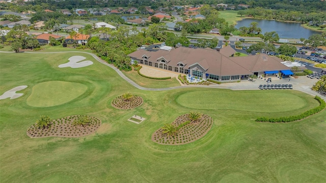 aerial perspective of suburban area with a nearby body of water and a local golf course