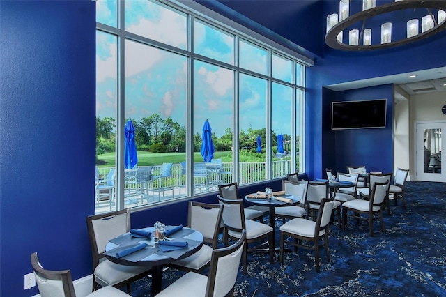 dining room featuring a towering ceiling