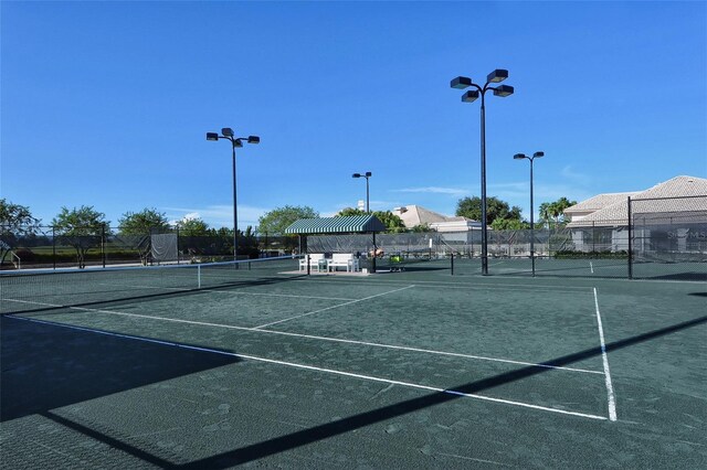 view of tennis court with fence