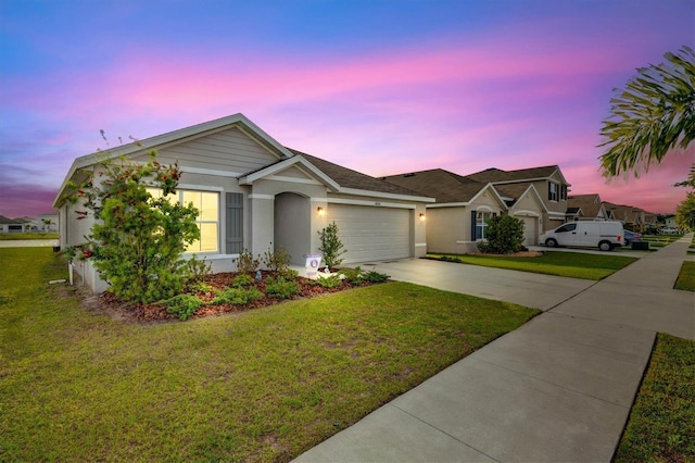 single story home featuring driveway, a garage, a yard, and stucco siding