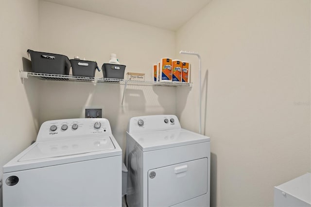 laundry room featuring washing machine and clothes dryer