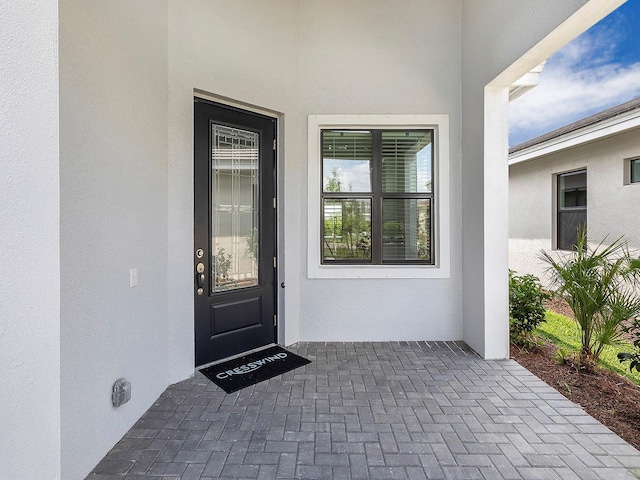 doorway to property with stucco siding
