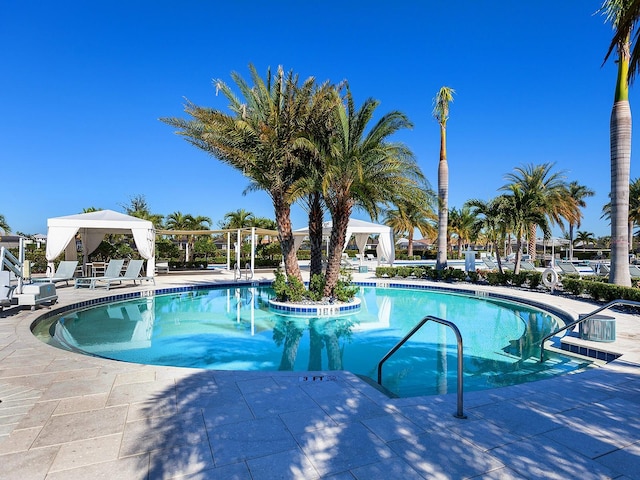 community pool featuring a gazebo and a patio area