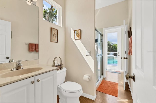 bathroom featuring plenty of natural light, a shower stall, and toilet