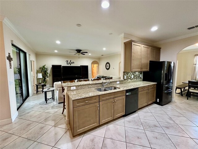 1568 Cordgrass Way, Lakeland, FL 33813 - kitchen featuring black appliances, arched walkways, a peninsula, recessed lighting, and backsplash