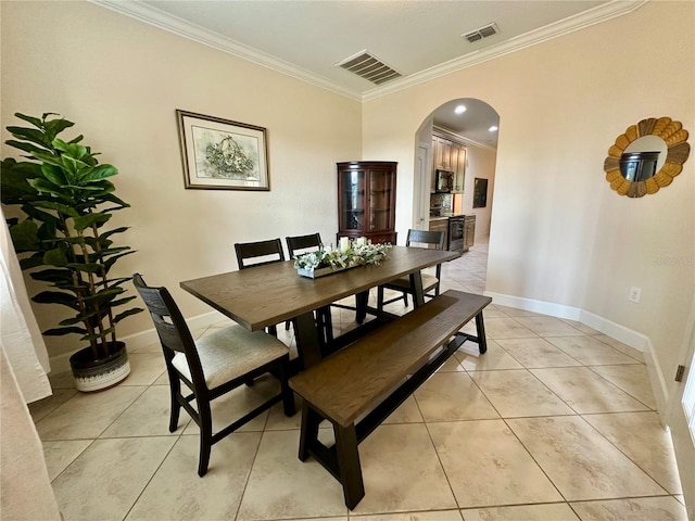 1568 Cordgrass Way, Lakeland, FL 33813 - dining area featuring arched walkways, crown molding, and light tile patterned floors