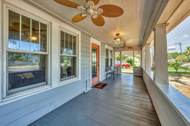 wooden terrace featuring a porch and a ceiling fan