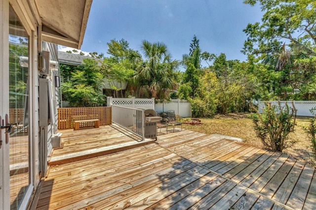 wooden deck with a fenced backyard