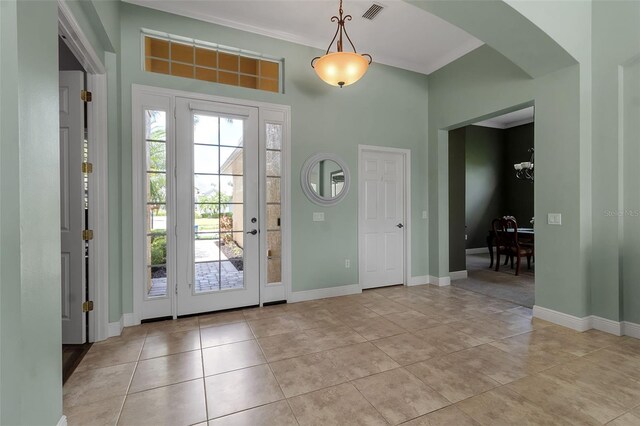 1542 Ormond Ter, Parrish, FL 34219 - foyer featuring plenty of natural light, arched walkways, light tile patterned flooring, and baseboards