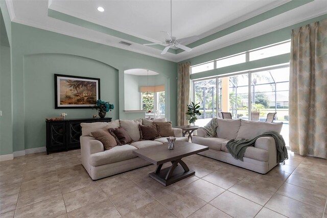 1542 Ormond Ter, Parrish, FL 34219 - living room featuring a raised ceiling, ceiling fan, crown molding, recessed lighting, and baseboards