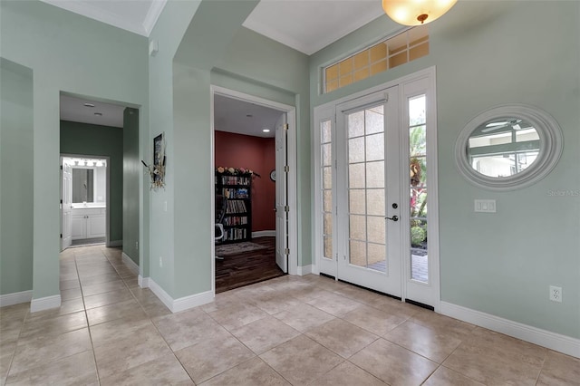 1542 Ormond Ter, Parrish, FL 34219 - foyer with plenty of natural light, light tile patterned floors, baseboards, and a towering ceiling