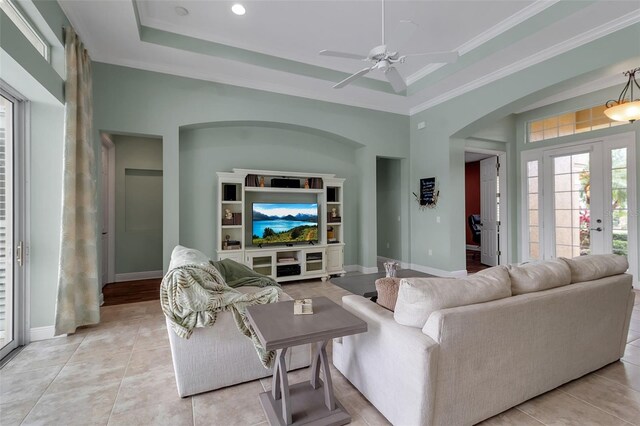 1542 Ormond Ter, Parrish, FL 34219 - living area with a ceiling fan, light tile patterned flooring, baseboards, ornamental molding, and arched walkways
