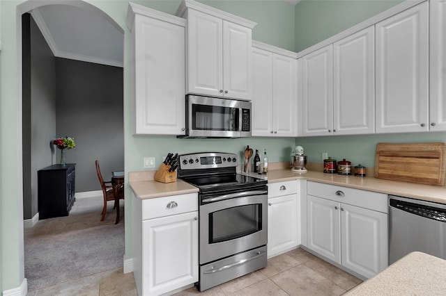 1542 Ormond Ter, Parrish, FL 34219 - kitchen featuring stainless steel appliances, arched walkways, light countertops, white cabinets, and baseboards