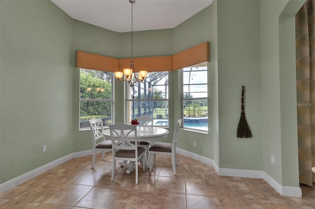 1542 Ormond Ter, Parrish, FL 34219 - dining area featuring a chandelier, plenty of natural light, baseboards, and a towering ceiling