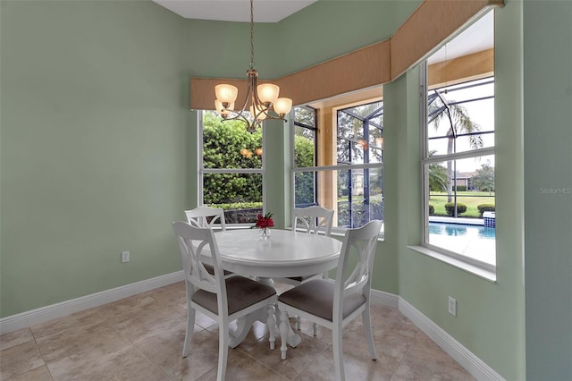 1542 Ormond Ter, Parrish, FL 34219 - dining area with a chandelier, baseboards, and light tile patterned flooring