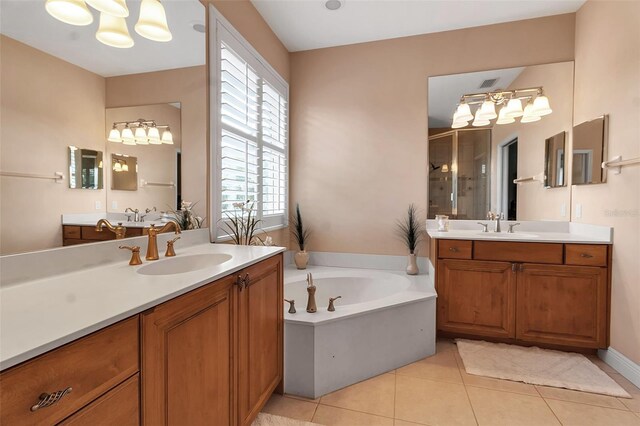 1542 Ormond Ter, Parrish, FL 34219 - full bathroom featuring a shower stall, tile patterned floors, a garden tub, two vanities, and a chandelier