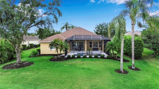 1542 Ormond Ter, Parrish, FL 34219 - back of house with a patio, a lawn, and stucco siding