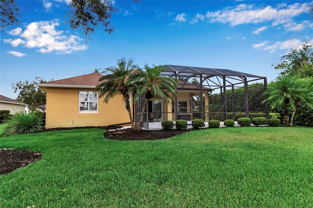 1542 Ormond Ter, Parrish, FL 34219 - back of house featuring stucco siding, a lawn, and glass enclosure