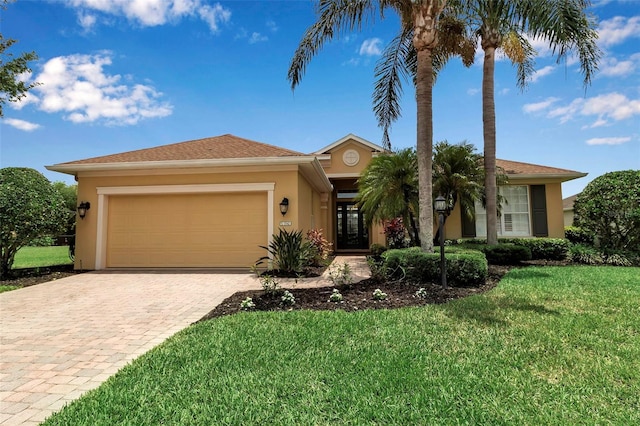 1542 Ormond Ter, Parrish, FL 34219 - ranch-style house featuring stucco siding, decorative driveway, an attached garage, and a front lawn