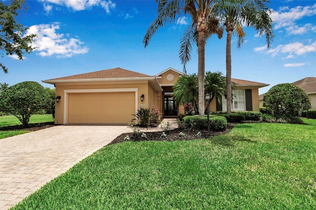1542 Ormond Ter, Parrish, FL 34219 - single story home featuring stucco siding, a garage, decorative driveway, and a front yard