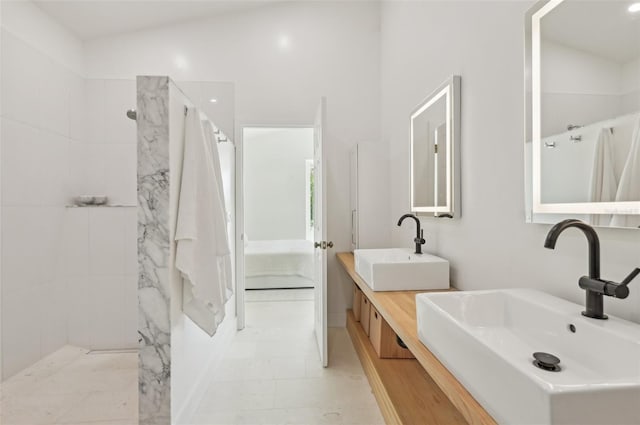 ensuite bathroom with double vanity and a shower