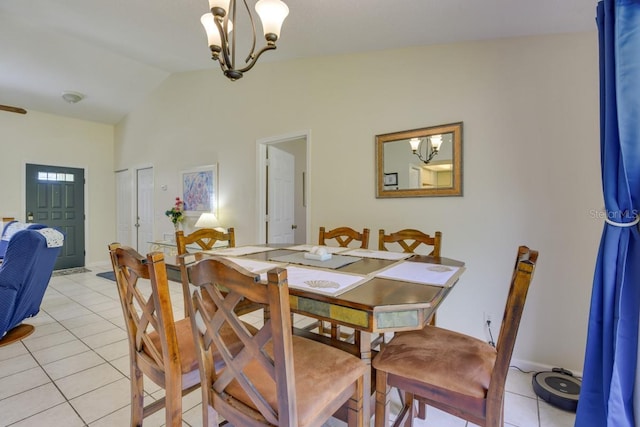 dining room with a chandelier, light tile patterned floors, and vaulted ceiling