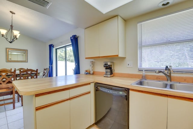 kitchen featuring black dishwasher, a peninsula, a sink, lofted ceiling, and light tile patterned floors