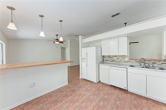 kitchen with white appliances, ceiling fan, a sink, tasteful backsplash, and white cabinets