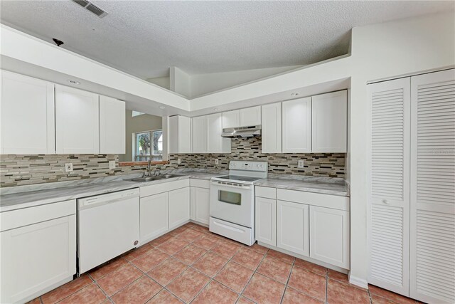 kitchen featuring white appliances, a sink, under cabinet range hood, a textured ceiling, and backsplash