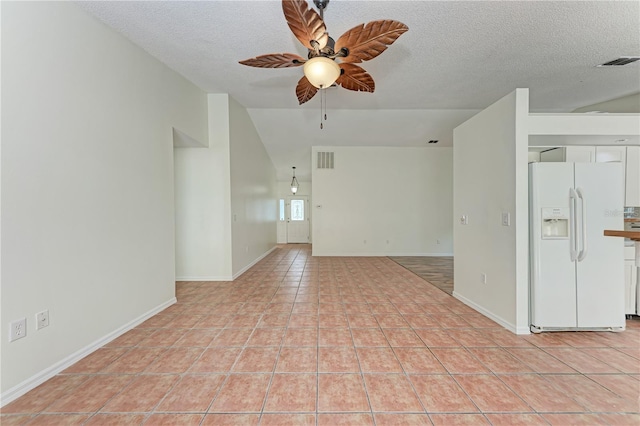 empty room featuring a ceiling fan, a textured ceiling, light tile patterned flooring, baseboards, and high vaulted ceiling