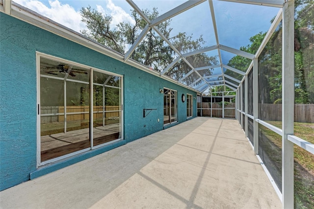 unfurnished sunroom with ceiling fan and lofted ceiling
