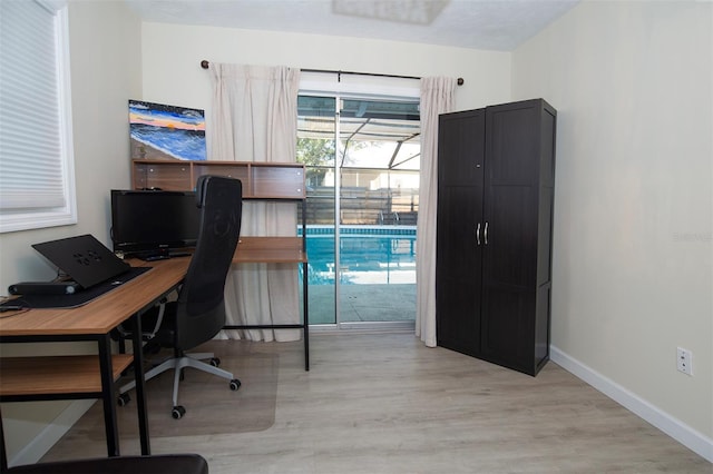 home office featuring light wood-style floors and baseboards