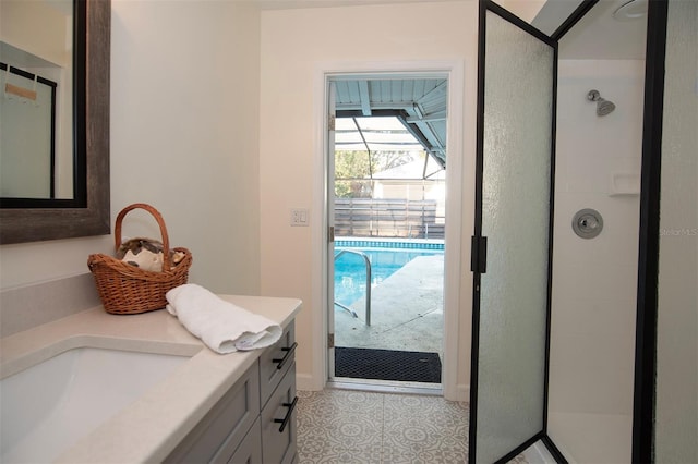 full bathroom featuring a stall shower, vanity, and tile patterned floors