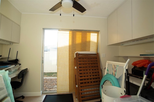 interior space featuring plenty of natural light, ceiling fan, light wood finished floors, and an office area