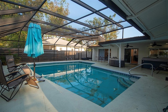 swimming pool featuring ceiling fan, fence, a patio, and glass enclosure