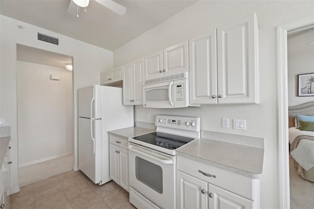 kitchen with white appliances, white cabinetry, light countertops, and a ceiling fan