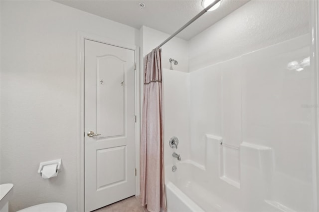 bathroom with toilet and shower / bath combo