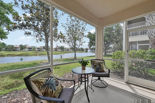 sunroom / solarium with a water view