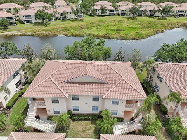 aerial view of residential area featuring a nearby body of water